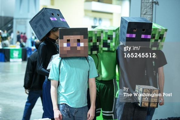 Students wearing decorated boxes on their heads and hip to  look like characters from the Minecraft video game